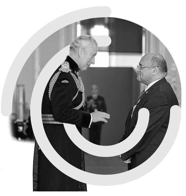 Amir receiving OBE from King