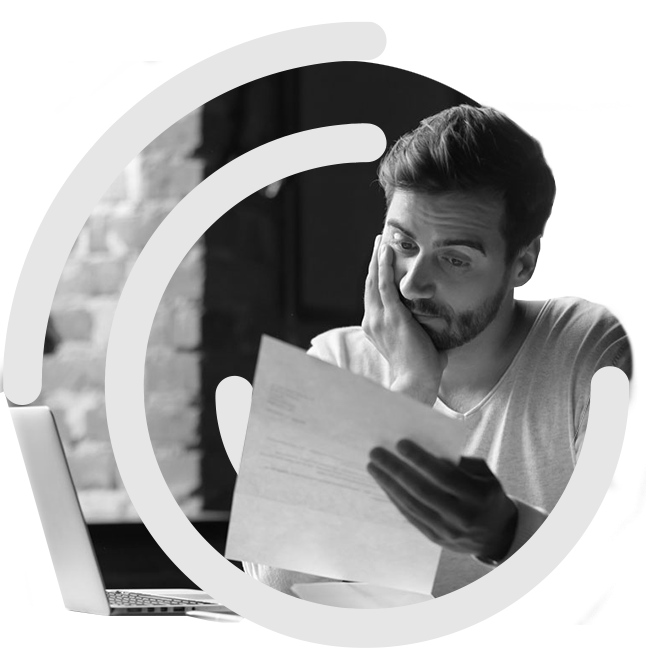 Man attempting to make sense of paperwork at desk